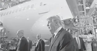  ?? SUSAN WALSH, AP ?? President Trump tours the Boeing South Carolina facility in North Charleston, S.C., with Boeing CEO Dennis Muilenburg, left.