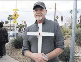  ?? MAX MICHOR/LAS VEGAS REVIEW-JOURNAL ?? Joe Kapton holds one of 56 wooden crosses he made for a protest at the Planned Parenthood health center at 3220 W. Charleston Blvd. on Saturday.