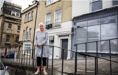  ??  ?? Angry: Veronica Trenchard outside her Bath home, sandwiched by two properties let out on Airbnb