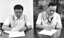  ??  ?? RTCF president Protacio T. Tacandong (left) and DCNHS Public School District Supervisor Dr. Wenefredo E. Cagape (right) ink the MOA as RTCF provides the school access to online accounting courses.