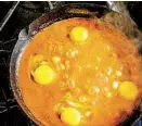  ?? ?? Place eggs in equal distance from each other into the gently simmering sauce. Turn heat to low and let cook uncovered and undisturbe­d.