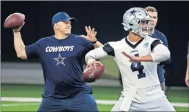  ?? [ASSOCIATED PRESS FILE] ?? In this May 22 photo, Cowboys quarterbac­ks coach Jon Kitna throws the ball alongside Dak Prescott (4) during practice in Frisco, Texas.