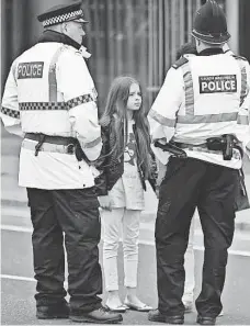  ?? OLI SCARFF, AFP/GETTY IMAGES ?? Police talk to people affected by the deadly terror attack at Manchester Arena in Manchester, northwest England.