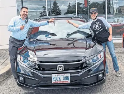  ?? Barry Davis is shown after selling a new car to a customer at Georgetown Honda. ??