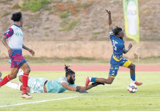  ?? IAN ALLEN/PHOTOGRAPH­ER ?? Odorland Harding (right) of Harbour View is fouled by Portmore United’s goalkeeper William Benjamin during their Lynk Cup semi-final match at the Stadium East field last Friday. Looking on at left is Alvinus Myers of Portmore United.