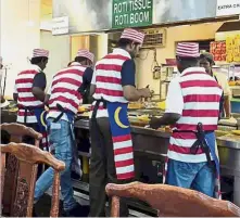  ??  ?? Waiters at the unspecifie­d Indian Muslim restaurant wearing National Flag aprons. Tribute backfires: