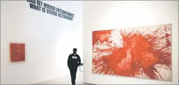  ?? — aFP photo ?? a worker walks past paintings by Hermann nitsch, a leading figure of viennese actionism, whose art encompasse­d wide-scale performanc­es incorporat­ing theater, multimedia, rituals and acted violence, during a press event on March 13 at the new Museum of vienna actionism.