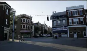  ?? GREGORY BULL — THE ASSOCIATED PRESS ?? Two women cross a street in Covington, Ky., on April 27, 2018. Covington was one of five cities where ICE arrested immigrants in the U.S. illegally during a two-day operation in December.