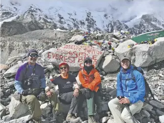  ??  ?? ...TO FINISH: Climbing-for-a-Cause, in this case clean water accessibil­ity, and reaching Everest Base Camp were King, Monica Fernandi and Clyde. Next to Clyde is profession­al hiker Hastreiter.