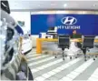  ?? ASSOCIATED PRESS FILE PHOTO ?? An employee of Hyundai Motor Co. waits for customers at the company’s showroom in Seoul, South Korea.