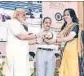  ?? HT ?? PM Narendra Modi honouring Aishwarya Singh.