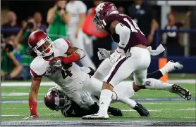  ?? AP PHOTO ?? Arkansas wide receiver Keon Hatcher (4) is tackled by Texas A&M defensive back Armani Watts, bottom, with help from defensive back Justin Evans, right, after Hatcher caught a pass.