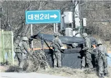  ?? AHN YOUNG-JOON/THE ASSOCIATED PRESS ?? South Korean soldiers erect a tent in Yeoncheon, South Korea, near the border with North Korea on Monday. North Korea fired four banned ballistic missiles that flew about 1,000 km.