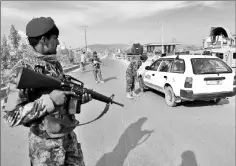  ??  ?? Afghan security personnel search passengers in a checkpoint on Highway One in — AFP photos