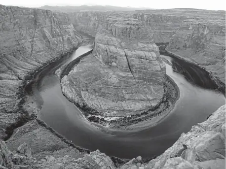  ?? Rhona Wise, AFP/Getty Images ?? The Colorado River wraps around Horseshoe Bend in the Glen Canyon National Recreation Area in Page, Ariz., in February 2017.