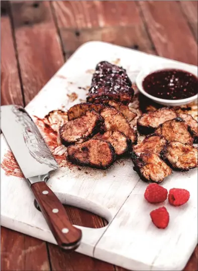  ?? REPRINTED WITH PERMISSION OF GIBBS- SMITH BOOKS. AUTHOR STEVE TILLETT; PHOTOGRAPH­Y SUSAN BARNSON HAYWARD ?? Raspberry pork loin: The raspberry sauce adds just the right amount of sweetness Recipe at https://bit.ly/2L9KUVE.