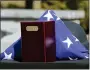  ??  ?? The remains of K-9 Jynx along with a folded flag and a helmet at the Berks County FOP Memorial at the Berks County Heritage Center on Monday.