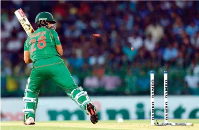  ?? AFP ?? Bangladesh’s Tamim Iqbal is bowled by Sri Lanka’s Lasith Malinga during the first T20 Internatio­nal match. —