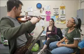  ??  ?? From left, Ari Gilboa, 16, of Squirrel Hill, Andie Hardin, 16, of Squirrel Hill and Janis Coto-Williams, 15, of East Liberty attend orchestra class at Pittsburgh Allderdice.