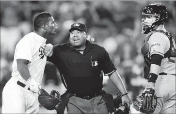  ?? Wally Skalij Los Angeles Times ?? COLORFUL PLAYERS such as Yasiel Puig, left, added to the lore of the Dodgers-Giants rivalry. Here, he glares toward Giants catcher Buster Posey after being hit by a pitch from Madison Bumgarner in a 2014 game.