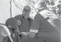  ?? COURANT FILE PHOTO ?? Navy veteran Theodore Freeman Jr., of Middletown, talks with Joshua Hamre, with supportive services for veterans families, during the 2019 Stand Down service fair.