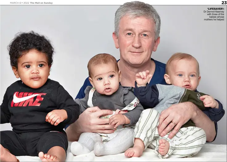  ?? ?? ‘LIFESAVER’: Dr Dermot Kearney with three of the babies whose mothers he helped