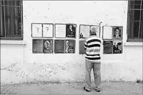  ??  ?? A man looks election posters of presidenti­al candidates in Tunis. (Photo: Reuters UK)