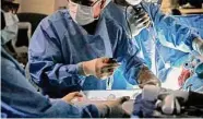  ?? Associated Press file photo ?? A transplant surgeon holds a kidney from a donor during a surgery in St. Louis in 2018.