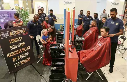  ??  ?? Cuts above: The barbers at work during their non-stop relay haircuts at Gurney Plaza in Penang.