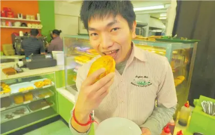  ?? Photo / Clinton Llewellyn ?? Co-owner and manager of Waipukurau’s Angkor Wat Bakery and Coffee Shop, Sopanharit­h “Henry” Chea, about to tuck into one of his store’s silver award-winning steak and gravy pies.