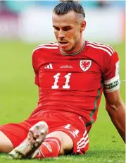  ?? ?? Oh no! Pupils watching the match in Cardiff show their agony as crestfalle­n Gareth Bale sits on pitch after defeat