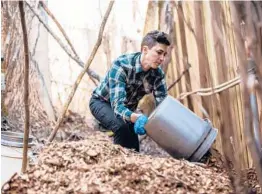  ?? MIKE BELLEME/THE NEW YORK TIMES 2015 ?? Katrina Spade, co-founder of Recompose, monitors the temperatur­e of wood chips at a facility in Cullowhee, North Carolina.