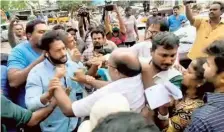  ?? ?? Public brawl: Supporters of Vamsi Krishna Srinivas Yadav and JSP corporator Mohammed Sadiq clash at One Town in Visakhapat­nam on Wednesday.
