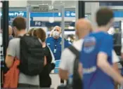  ?? JOHN J. KIM/CHICAGO TRIBUNE 2021 ?? Chicago is one of the least impacted cities in terms of airfare increases. Above, a TSA worker stands at Chicago O’Hare Internatio­nal Airport.