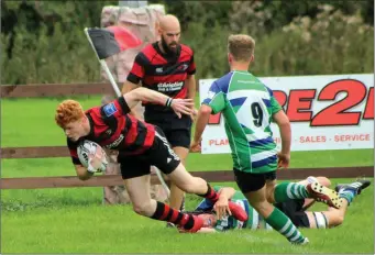  ??  ?? Tommy New scores the first try of the game for Arklow RFC. Photos: Yvette O Beirne