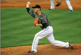  ?? Arkansas Democrat-Gazette/THOMAS METTHE ?? Arkansas Travelers’ Justin DeFratus throws a pitch at a recent game at Dickey-Stephens Park in North Little Rock. The team plays the Frisco RoughRider­s on Thursday.