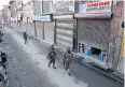  ?? AP ?? Indian paramilita­ry soldiers patrol a market during a strike in Srinagar yesterday.