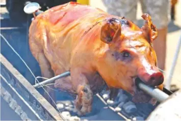  ?? STAFF FILE PHOTO ?? Dallas Williams went hog wild at last year’s Beast Feast, cooking an entire pig on the spit.