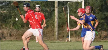  ??  ?? Fethard defender Colm Ryan in the act of clearing his lines as Jack Culleton of Gusserane moves in.