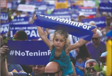  ?? Te Associated Press ?? ‘NOT AFRAID’: A young girl holds a sign reading "We are not afraid" in the Catalan language during a demonstrat­ion Saturday condemning the attacks that killed 15 people last week in Barcelona, Spain. The Islamic State group has claimed responsibi­lity...