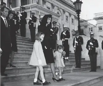  ??  ?? Above: Jackie Kennedy with Caroline, John Jnr and Bobby (behind) at the funeral of John F Kennedy in 1963. Right: John Jnr with his wife Carolyn Bessetteke­nnedy in 1997