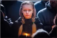  ?? ?? A relative holds a candle Feb. 22 during Roman Shevchenko’s funeral in Bila Tserkva, near Kyiv. Shevchenko, 40, was a civilian who joined the Ukrainian Armed Forces to defend his country when the war started. He was killed Feb. 9 in Vuhledar, a city in the Donetsk region.