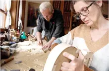  ?? ?? Bogdanoski (back) works on his last violin with Tatjana Miseva, a long-time work partner, in his workshop.