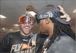  ?? Associated Press photo ?? Houston Astros’ Justin Verlander and Cameron Maybin celebrate after Game 7 of baseball’s American League Championsh­ip Series against the New York Yankees Saturday in Houston.