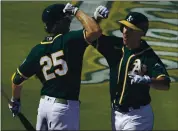  ?? MATT YORK — THE ASSOCIATED PRESS ?? The A’s Matt Olson, right, celebrates his two-run homer with Stephen Piscotty during the third inning Monday.