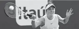  ?? LYNNE SLADKY/AP ?? Elina Svitolina returns to Ashleigh Barty during the semifinals of the Miami Open on Thursday in Miami Gardens, Fla. Barty won 6-3, 6-3.