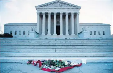  ?? Brendan Smialowski
AFP/ Getty I mages ?? FLOWERS OUTSIDE the U. S. Supreme Court pay tribute to Justice Antonin Scalia, who was found dead Saturday. Republican­s fear that without his voice, the court’s conservati­ve wing will lose its inf luence.
