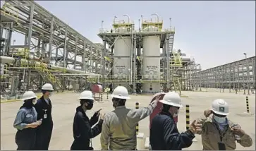  ?? Amr Nabil Associated Press ?? SAUDI Aramco engineers and journalist­s at the Hawiyah Natural Gas Liquids Recovery Plant in June.