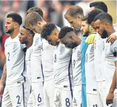  ??  ?? England players observe the silence before playing Lithuania
