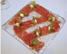  ??  ?? Black Angus carpaccio with whipped homemade ricotta, sugar tomatoes and rocket.